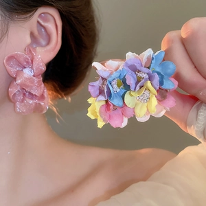 Detail of large chiffon floral earrings with pearls and soft pastel fabric petals