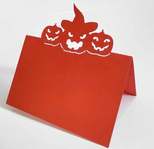 Detail of red Halloween place card with intricate pumpkin cutout in a 3D folded design