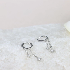 Silver hoop earrings with sparkling zircon stones and delicate star-shaped tassels charms
