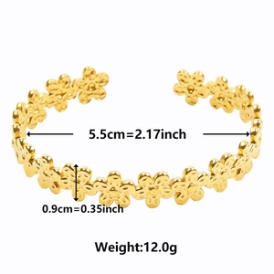 Detail view of 18k gold floral cuff bracelet with 5.5cm inner diameter and 0.9cm width
