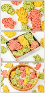 Macro details of Santa, reindeer, and gingerbread man cookies in a festive gift box