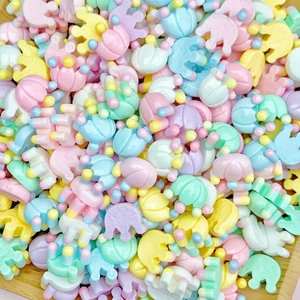 Macro view of macaron-colored resin tulip and elephant DIY craft accessories
