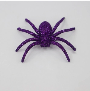 Detailed view of a purple glittery spider decoration for Halloween party prop decor