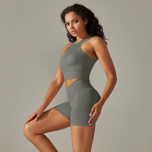 Close-up of seamless dark gray knitted sports vest and high waist shorts on fitness model