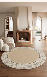 Detailed close-up of a French vintage beige round carpet with black floral border in a living room