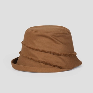 Detailed view of brown cotton canvas bucket hat with decorative raw-edge spiral fringe