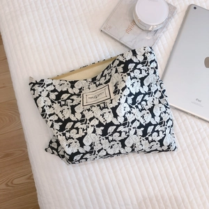 Floral cotton makeup bag with white leaf patterns and Time to Party woven label