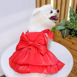Detail of red satin pet dress featuring a large bow and metal D-ring for leash attachment