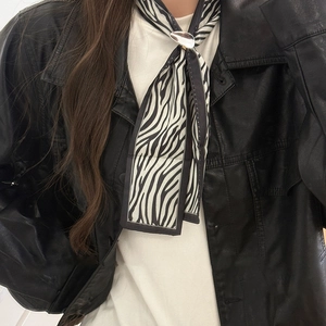 Zebra print silk scarf necklace with polished metal buckle shown on a model