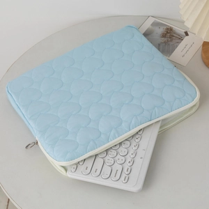 Detailed view of quilted heart pattern on light blue 13-inch laptop sleeve cover
