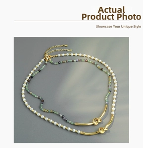 Detail of beaded necklace with colorful natural stones, pearls and a golden knot metal tube