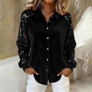 Detail of black velvet shirt featuring sequin sleeves and white buttons on the cuffs
