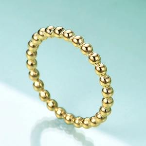 Macro shot of 2mm golden beaded stainless steel ring with elegant reflection
