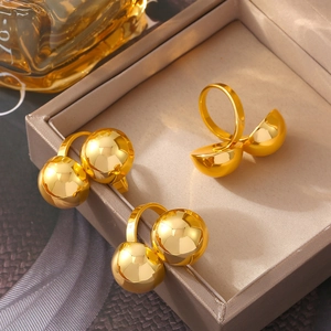 Three chunky 18k gold plated open rings with spherical design in a jewelry box