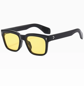 Macro detail of retro rectangular sunglasses with black frame and yellow lenses