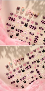 Detail of 3D bunny and heart nail art stickers with pink checkerboard patterns