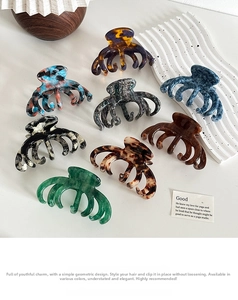 Flat lay of multiple acetate hair claws in various marble and tortoiseshell patterns