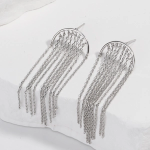 Silver crescent moon fringe earrings with delicate tassels on white stone base