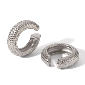 Detailed view of silver stainless steel ear cuff with textured scale pattern and hollow design
