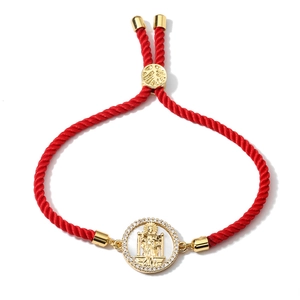Adjustable red woven bracelet with gold religious medal and sparkling cubic zirconia