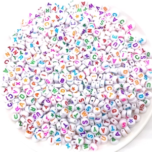 Assorted white acrylic alphabet beads with colorful letters and hearts for jewelry making