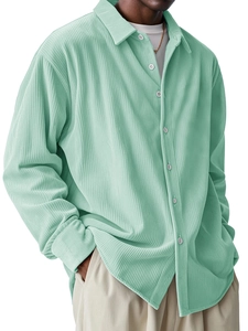 Detail of mint green corduroy texture and button-down collar on men's long sleeve shirt