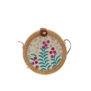 Handwoven round rattan shoulder bag with colorful shell floral inlay and leather strap