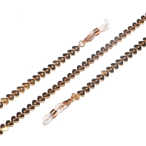 Golden heart-shaped link glasses chain with silicone loops on white background