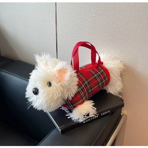 Detail of white plush Westie dog bag wearing a red plaid vest with a top handle