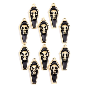 Detailed macro view of ten gold-toned vampire skull coffin charms for DIY jewelry making