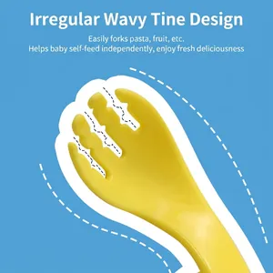 Yellow baby training fork with wavy tines on blue background for self-feeding