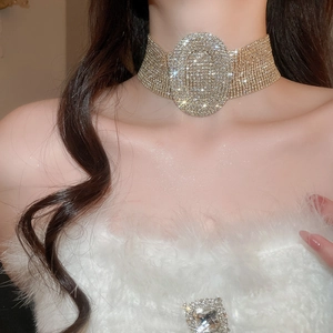 Detailed view of luxury wide choker necklace with oval crystal center on a model
