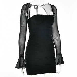 Detail eines schwarzen Bodycon-Kleides mit Mesh-Ärmeln und strukturierter Raffung