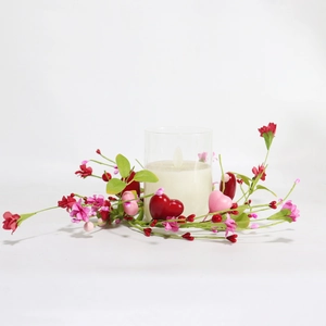 Close-up of Valentine candle ring with red and pink hearts, berries and LED light