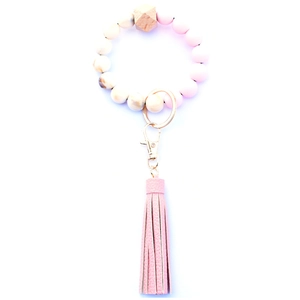 Close-up of pink and marble silicone bead keychain with wood bead and PU leather tassel