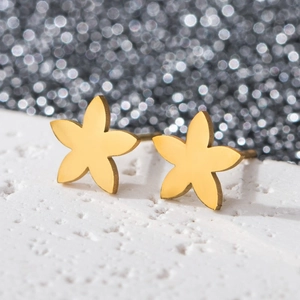Macro shot of 18K gold plated stainless steel five-petal flower stud earrings on white stone