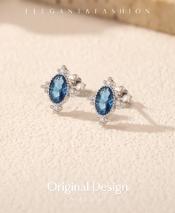 Macro shot of vintage S925 silver stud earrings with blue oval gemstone and zircons
