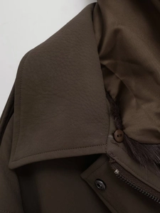Detail of brown faux leather jacket collar with soft fur trim and metal zipper