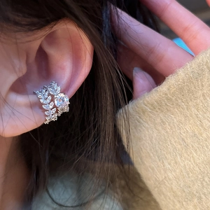 Silver hollow leaf ear cuff with sparkling zircon crystals worn on a female ear