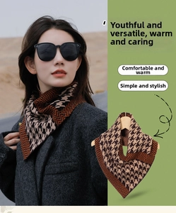 Close-up of houndstooth and wavy patterned V-shaped knit scarf for warmth