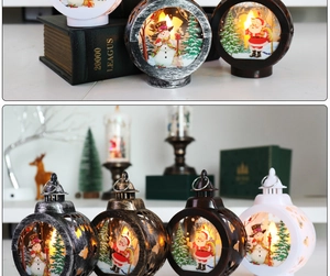 Detail of Christmas lantern with warm LED light featuring Santa and snowman illustrations