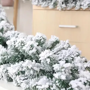 Flocked Christmas garland with green pine needles and artificial snow for holiday decor