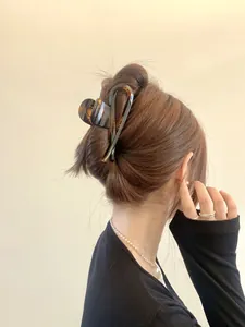 Detail of tortoise shell claw clip securing a bun hairstyle for an elegant look