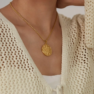 Golden sun totem pendant necklace with twisted rope chain on a model neck