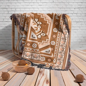 Close-up of Bohemian woven blanket with geometric patterns and colorful tassel edges