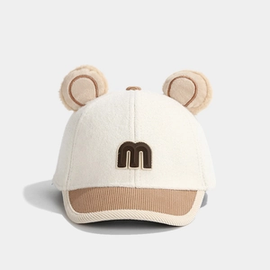 Detail of baby wool baseball cap with letter M and cute plush bear ears decoration