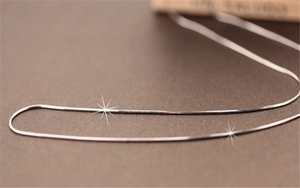 Macro shot of 1mm silver plated snake bone chain with shimmering starlight effect