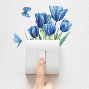 Close-up of blue tulip and butterfly wall stickers applied around a white light switch