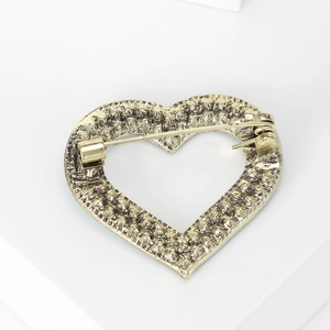 Vintage bronze heart-shaped brooch pin with textured surface and safety clasp