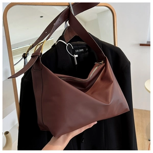 Detail of soft dark brown leather hobo bag with adjustable strap and zipper closure